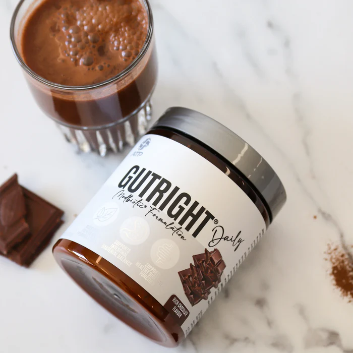 Cutright protein powder jar with a glass of chocolate shake and chocolate pieces on a marble surface