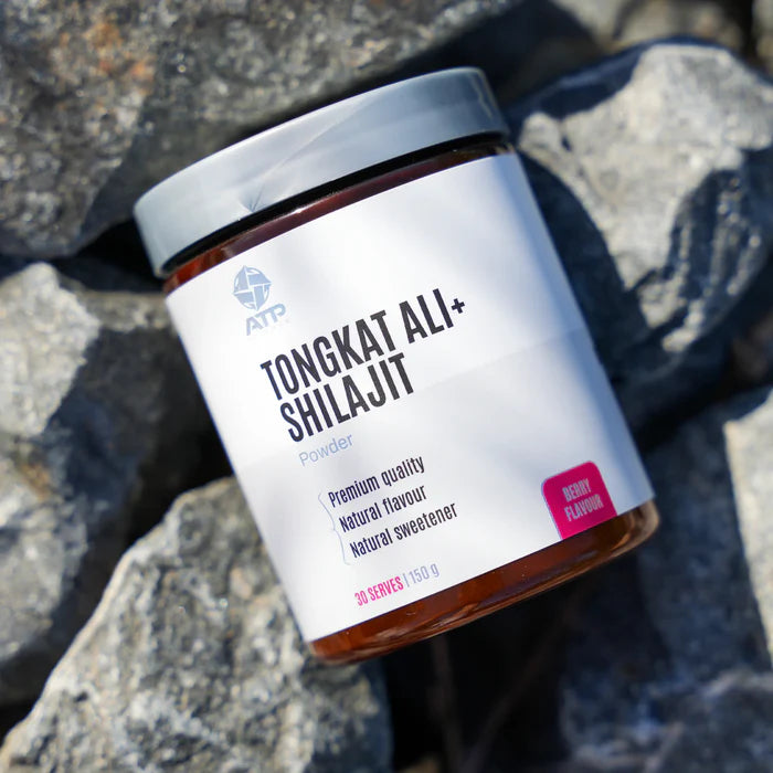 Jar of Tongkat Ali + Shilajit powder on a rocky surface
