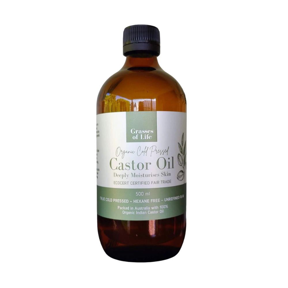 A bottle of Grasses of Life Organic Castor Oil with a label showing product details, contained in an amber glass bottle with a black cap.