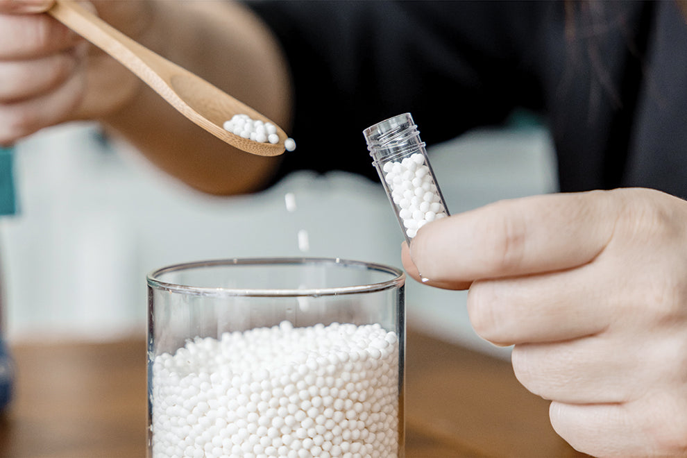 Jaime Chew creating natural beauty solutions in her wellness apothecary, blending herbal ingredients.