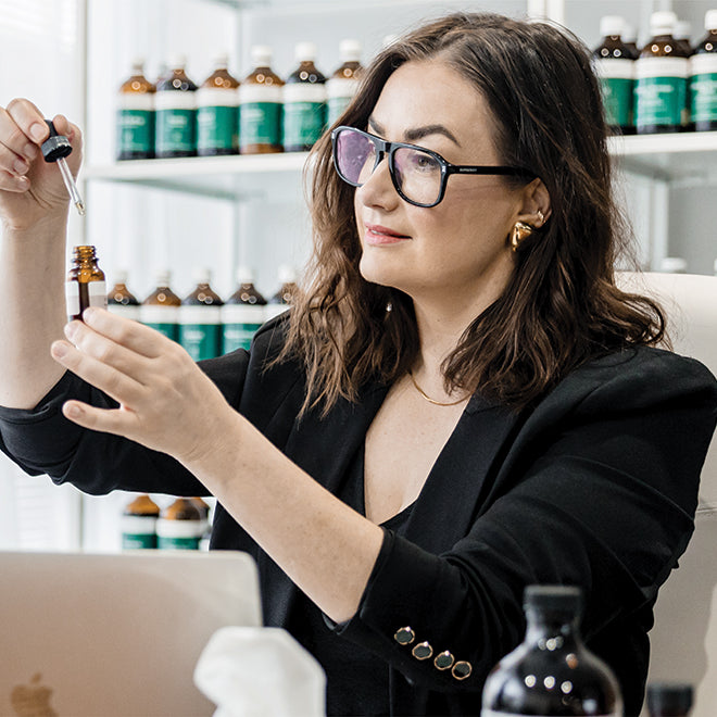 Jaime Chew carefully formulating natural remedies with a focus on ingredients.