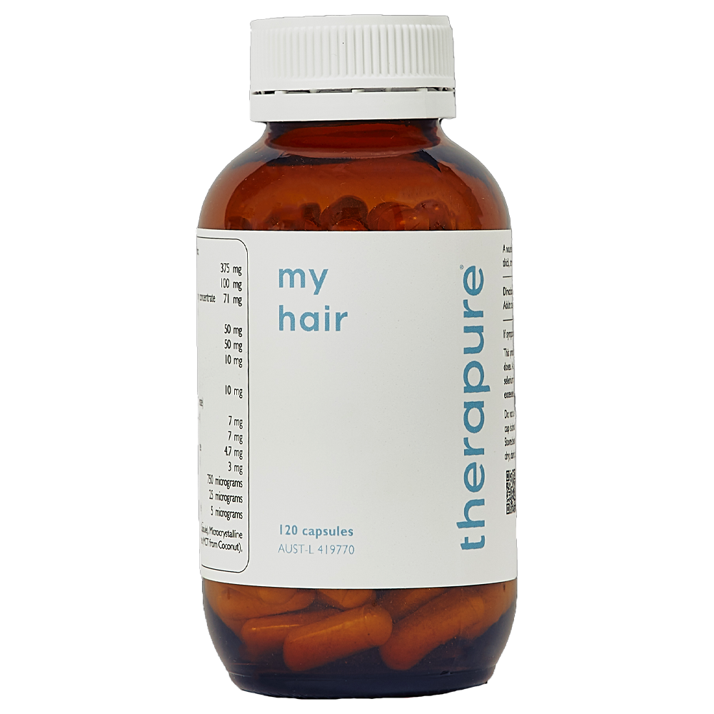 Bottle of 'therapure my hair' capsules on a white background
