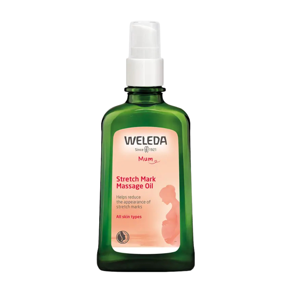 A bottle of Weleda Stretch Mark Massage Oil with a green label featuring a mother and child graphic, indicating it is for all skin types and helps prevent stretch marks.