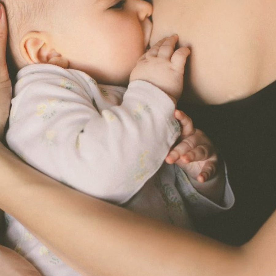 Mother breastfeeding her baby, soft natural light