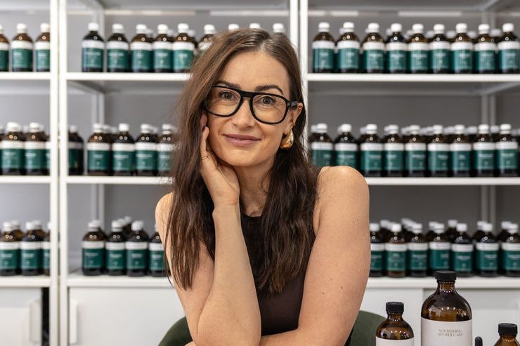 Naturopath from the Nourishing Apothecary clinical team with herbal tonics in the clinic