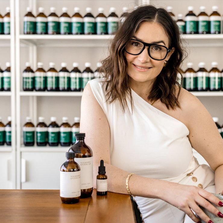 Naturopath from the Nourishing Apothecary clinical team with herbal tonics in the clinic