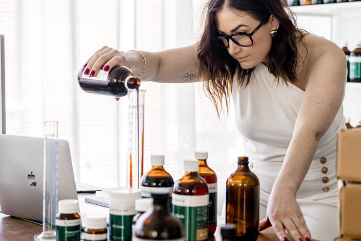 A Naturopath from the clinical team compounding a herbal prescription at the clinic bench