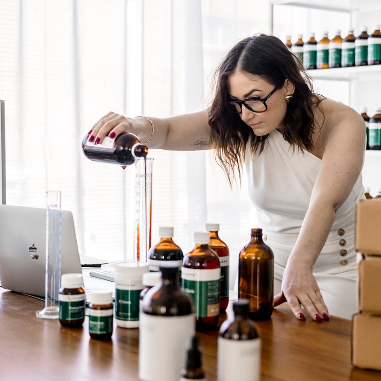 A Naturopath from the clinical team compounding a herbal prescription at the clinic bench
