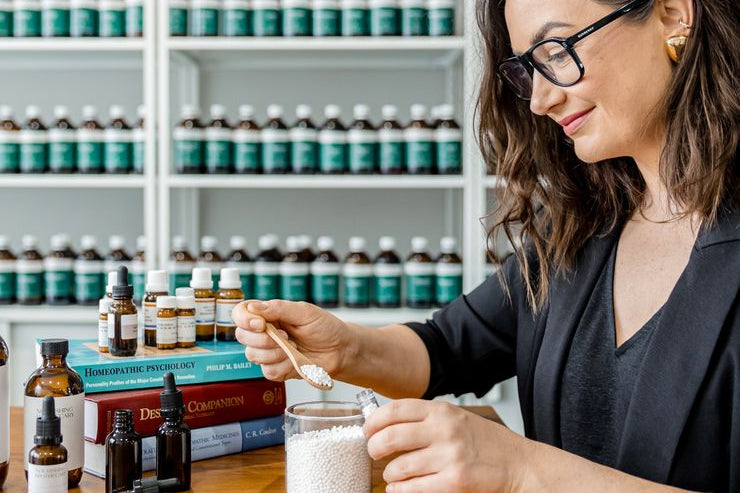 Jaime compounding a herbal prescription at her clinic bench