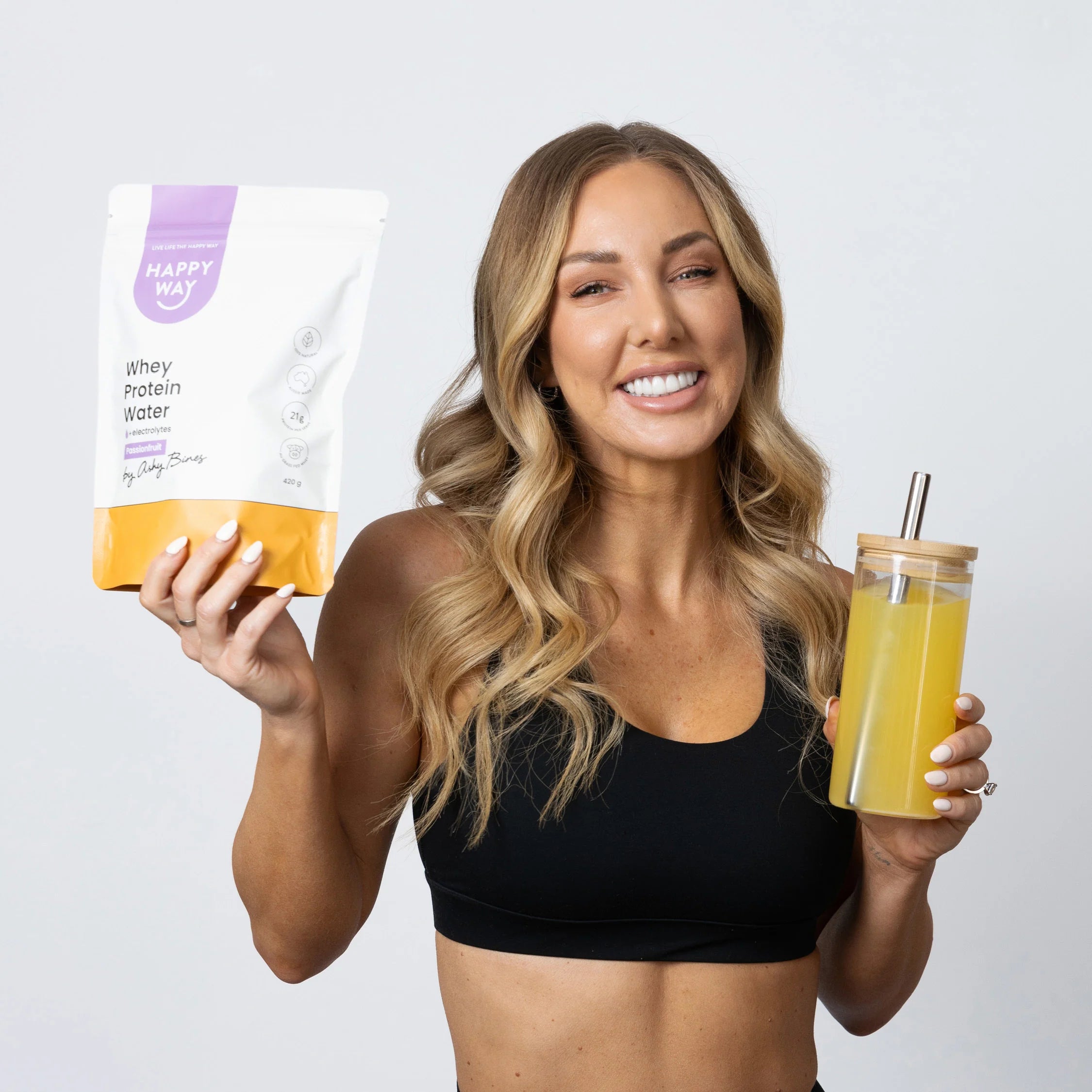 Refreshing Happy Way Passionfruit Protein Water in a glass with fruit