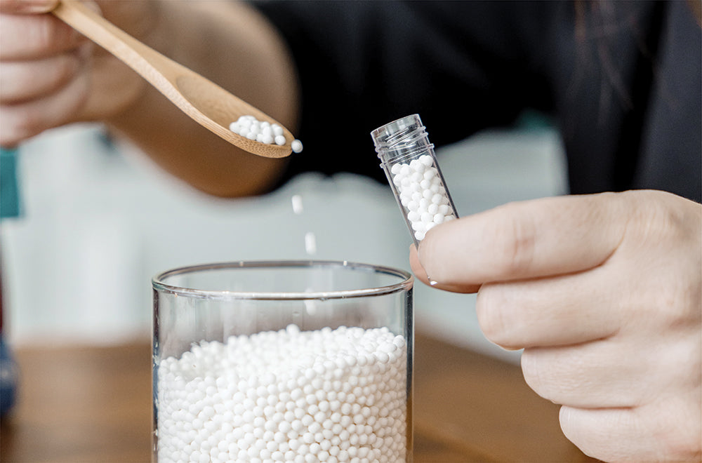 Jaime Chew creating natural beauty solutions in her wellness apothecary, blending herbal ingredients.