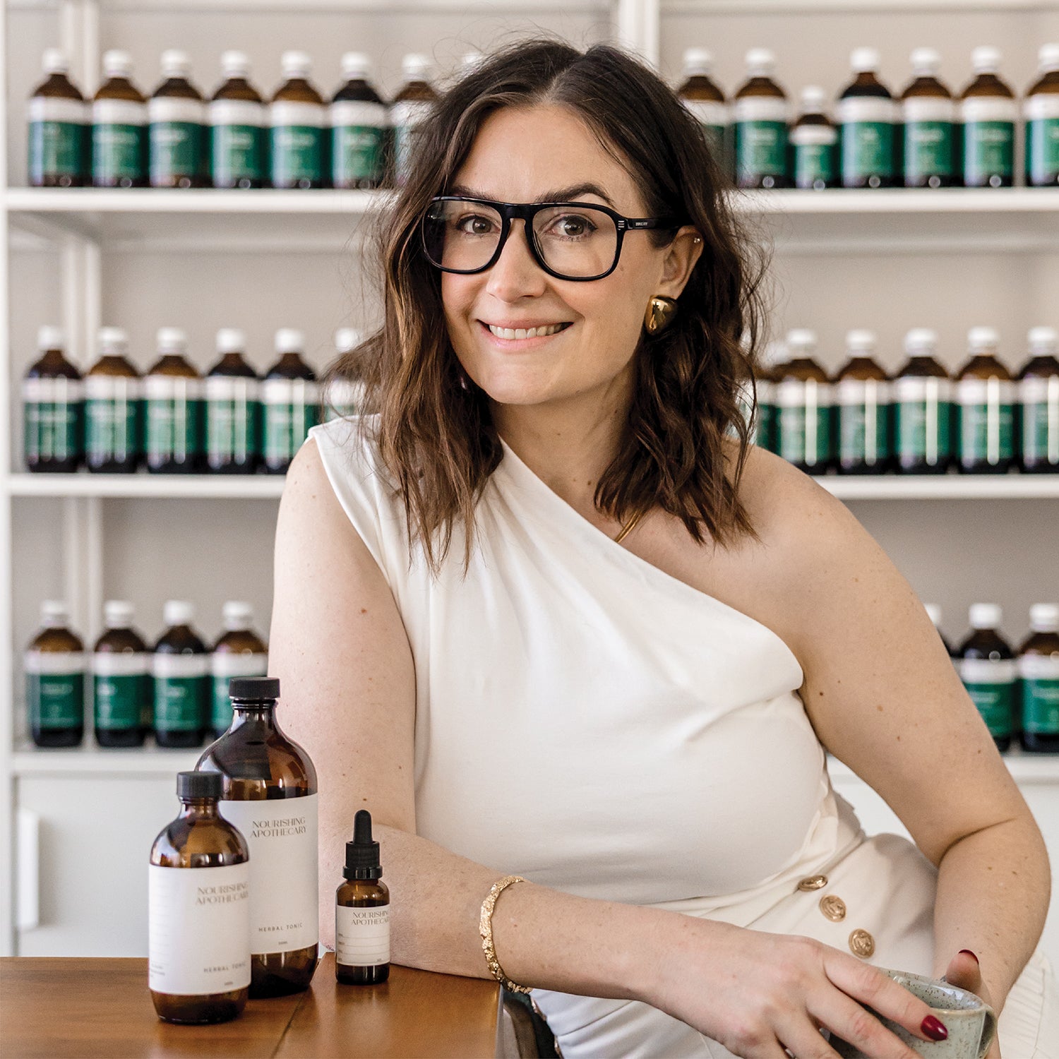 Jaime Chew creating natural beauty solutions in her wellness apothecary, blending herbal ingredients.