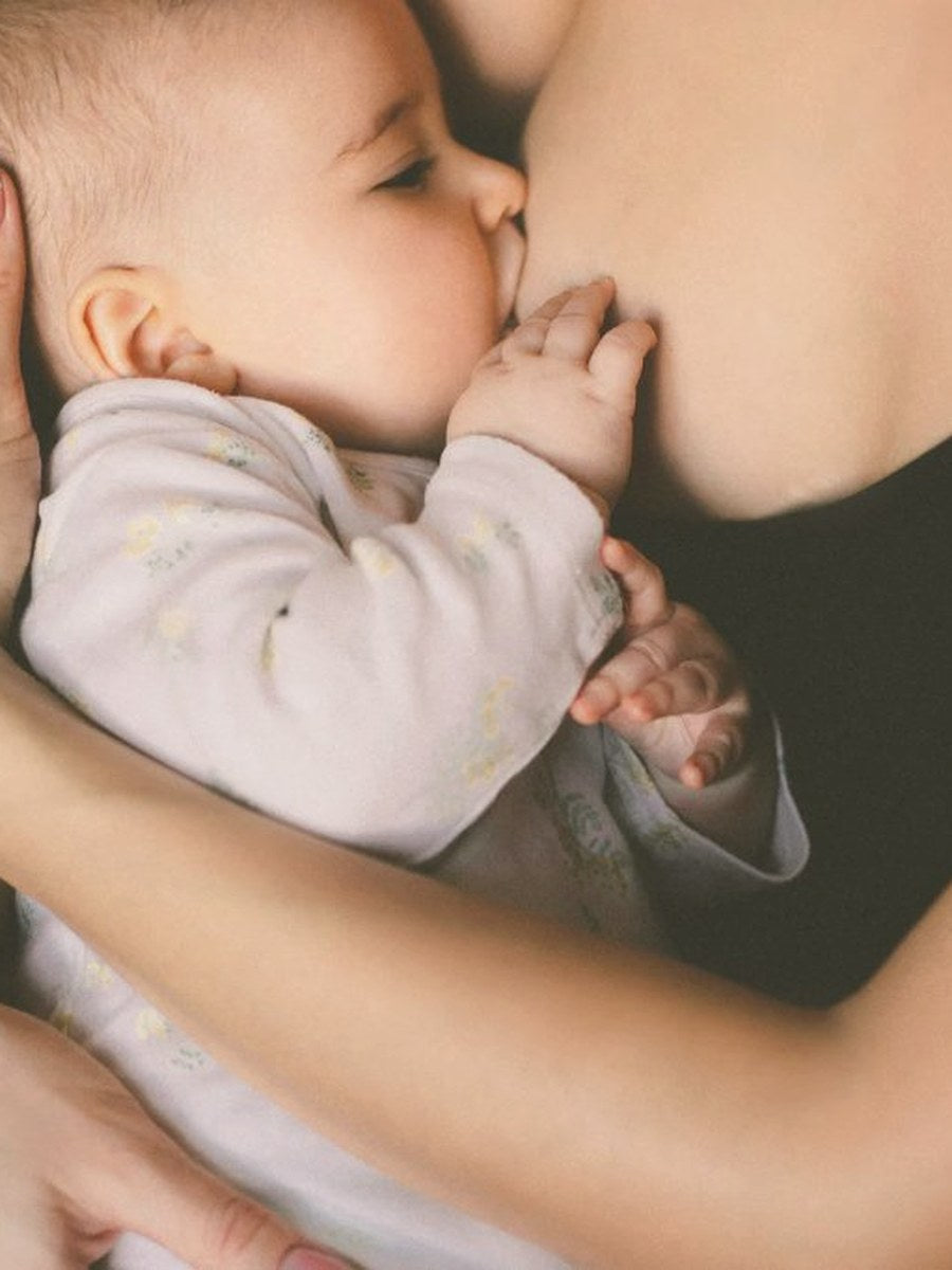 Mother breastfeeding her baby, soft natural light