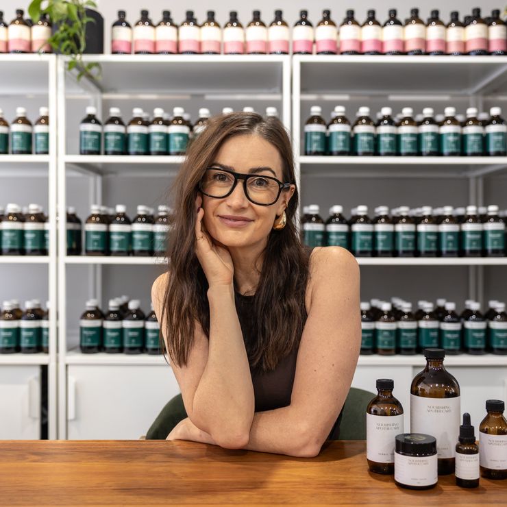 Naturopath from the Nourishing Apothecary clinical team with herbal tonics in the clinic