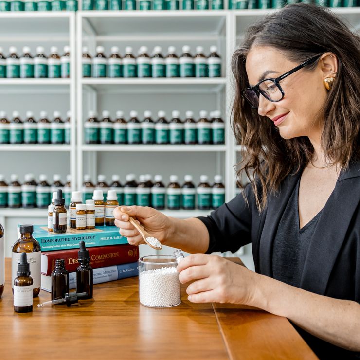 Jaime compounding a herbal prescription at her clinic bench